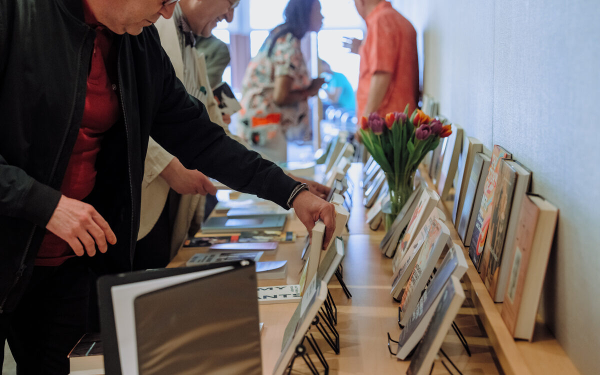 Guests explore the rich collection of new titles at the Authors in the Humanities reception, an annual event that showcases books published by NYU faculty and staff.